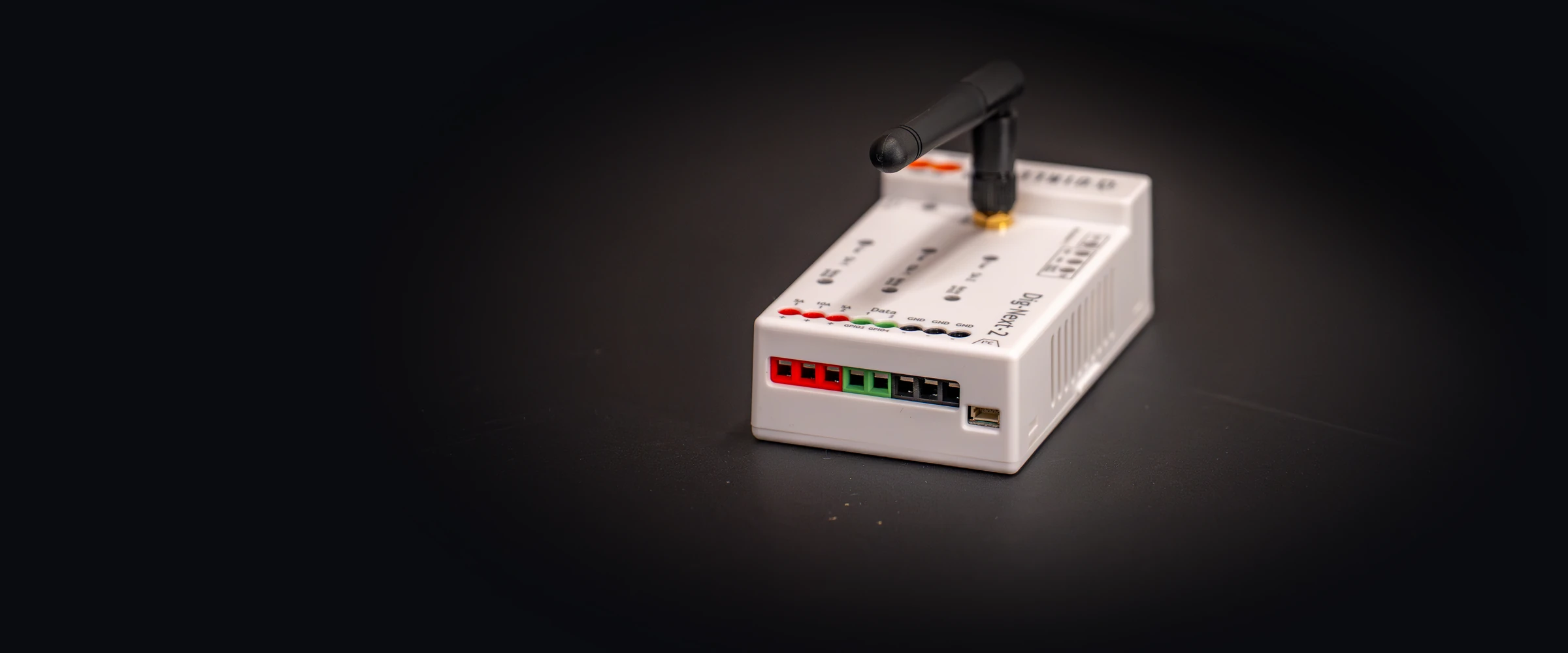QuinLED Dig-Next-2 WLED addressable LED controller with antenna on a dark surface